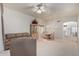 Living room with light carpet, leather couches, and dining area at 11553 W Sonoran Ct, Surprise, AZ 85378