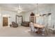 Living room with light carpet, leather couches, and dining area at 11553 W Sonoran Ct, Surprise, AZ 85378