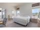 Bright main bedroom with king-size bed and private door to patio at 11553 W Sonoran Ct, Surprise, AZ 85378