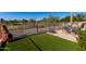 Patio with seating area, artificial turf, and golf course view at 11553 W Sonoran Ct, Surprise, AZ 85378