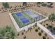 Aerial view of four pickleball courts with surrounding landscaping and benches at 14778 W Tether Trl, Surprise, AZ 85387