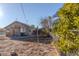 Back of house showing a small, older home needing renovation at 16039 N Hollyhock St, Surprise, AZ 85378