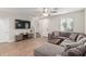 Living room with sectional sofa, TV, and staircase at 1723 S 83Rd Way, Mesa, AZ 85209