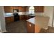 Kitchen with wood cabinets, tile floor, and an island at 17345 N Costa Brava Ave, Maricopa, AZ 85139