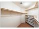 Large walk-in closet with custom shelving and shoe storage at 20802 N Grayhawk Dr # 1087, Scottsdale, AZ 85255