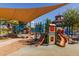 Modern playground with shade sails and play structures at 21325 N 260Th Ln, Buckeye, AZ 85396