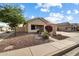 House exterior showcasing a well-maintained front yard and landscaping at 21995 N 76Th Ln, Peoria, AZ 85383