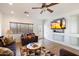 Bright living room with a large TV and comfortable seating at 21995 N 76Th Ln, Peoria, AZ 85383