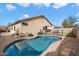 Kidney shaped pool with brick coping and surrounding landscaping at 21995 N 76Th Ln, Peoria, AZ 85383