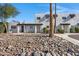 Front view of a remodeled light-colored stucco building with a rock garden at 2415 N 71St St # D, Scottsdale, AZ 85257
