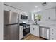 Updated kitchen with white cabinets and stainless steel appliances at 2415 N 71St St # D, Scottsdale, AZ 85257