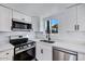 Modern kitchen features white cabinets, stainless steel appliances, and quartz countertops at 2415 N 71St St # D, Scottsdale, AZ 85257