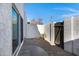 Private backyard patio with gravel and wooden gate at 2415 N 71St St # D, Scottsdale, AZ 85257