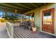 Covered porch with wooden floors, seating, and stained-glass door at 27852 N 79Th St, Scottsdale, AZ 85266