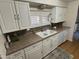 White cabinets, double sink, and neutral countertops at 4065 E University Dr # 373, Mesa, AZ 85205