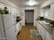 Kitchen features white cabinets, modern appliances, and wood flooring at 4065 E University Dr # 373, Mesa, AZ 85205