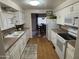 White kitchen with modern appliances and tile backsplash at 4065 E University Dr # 373, Mesa, AZ 85205