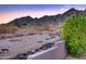 Landscaped backyard with gravel, rock features, and mountain views at 10030 N 23Rd St, Phoenix, AZ 85028