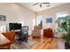 Home office with hardwood floors, large windows, and comfortable seating at 10030 N 23Rd St, Phoenix, AZ 85028