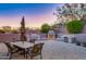 Outdoor kitchen with built-in grill, fireplace, and dining area at 10030 N 23Rd St, Phoenix, AZ 85028