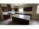 Kitchen with an island, dark cabinets, and white subway tile at 1167 W Dana Dr, San Tan Valley, AZ 85143