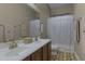 Clean bathroom with double vanity, shower/tub combo, and tile flooring at 11918 W Jessie Ln, Sun City, AZ 85373