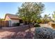 Spacious backyard with gravel landscaping, mature trees, and a covered patio at 12838 S 40Th Pl, Phoenix, AZ 85044