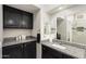 Bathroom with dark wood cabinets, granite countertop, and a vessel sink at 14209 W Sky Hawk Dr, Sun City West, AZ 85375