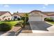 Single story home with two-car garage and manicured lawn at 14209 W Sky Hawk Dr, Sun City West, AZ 85375