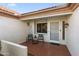 Welcoming front porch with tiled flooring and seating area at 14209 W Sky Hawk Dr, Sun City West, AZ 85375