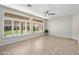 Living room with tile floors, plantation shutters, and backyard view at 14209 W Sky Hawk Dr, Sun City West, AZ 85375