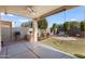 Private backyard with covered patio and grassy area at 17221 N Thornberry Dr, Surprise, AZ 85374