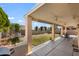 Covered patio overlooks a spacious backyard with grassy lawn at 17221 N Thornberry Dr, Surprise, AZ 85374