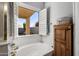 Relaxing bathroom with soaking tub and view to backyard at 17221 N Thornberry Dr, Surprise, AZ 85374