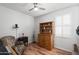 Bright bedroom with wood floors, window shutters, and built-in shelving at 17221 N Thornberry Dr, Surprise, AZ 85374