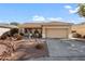 Single-story house with a two-car garage and desert landscaping at 17221 N Thornberry Dr, Surprise, AZ 85374