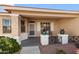 Covered front porch with seating and attractive planters at 17221 N Thornberry Dr, Surprise, AZ 85374
