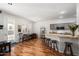 Kitchen with granite counters, island with seating, and wood floors at 17221 N Thornberry Dr, Surprise, AZ 85374