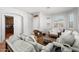 Living room with neutral decor, wood floors, and view into kitchen at 17221 N Thornberry Dr, Surprise, AZ 85374