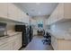 Laundry room with built-in workspace and white shaker cabinets at 17421 E Desert Vista Trl, Rio Verde, AZ 85263