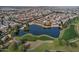 Aerial view of a community with a lake and golf course at 18048 W Spencer Dr, Surprise, AZ 85374