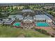 Aerial view of community with clubhouse, pool, and golf course at 18048 W Spencer Dr, Surprise, AZ 85374