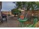 Small backyard with grill, small table and chairs, and a variety of plants at 18048 W Spencer Dr, Surprise, AZ 85374