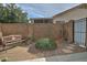 Small backyard patio with seating area, decorative plants, and a gate at 18048 W Spencer Dr, Surprise, AZ 85374