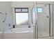 Bathroom boasts a shower, bathtub, and updated vanity at 18048 W Spencer Dr, Surprise, AZ 85374