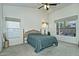 Bright bedroom with carpeted floor, window blinds, and ceiling fan at 18048 W Spencer Dr, Surprise, AZ 85374