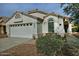 One-story home with two-car garage and landscaped front yard at 18048 W Spencer Dr, Surprise, AZ 85374