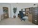 Home office with wood desk, chair, and built-in shelving at 18048 W Spencer Dr, Surprise, AZ 85374