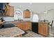 Kitchen with granite countertops, oak cabinets, and a breakfast bar at 18048 W Spencer Dr, Surprise, AZ 85374