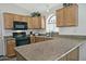Spacious kitchen featuring granite countertops and oak cabinets at 18048 W Spencer Dr, Surprise, AZ 85374